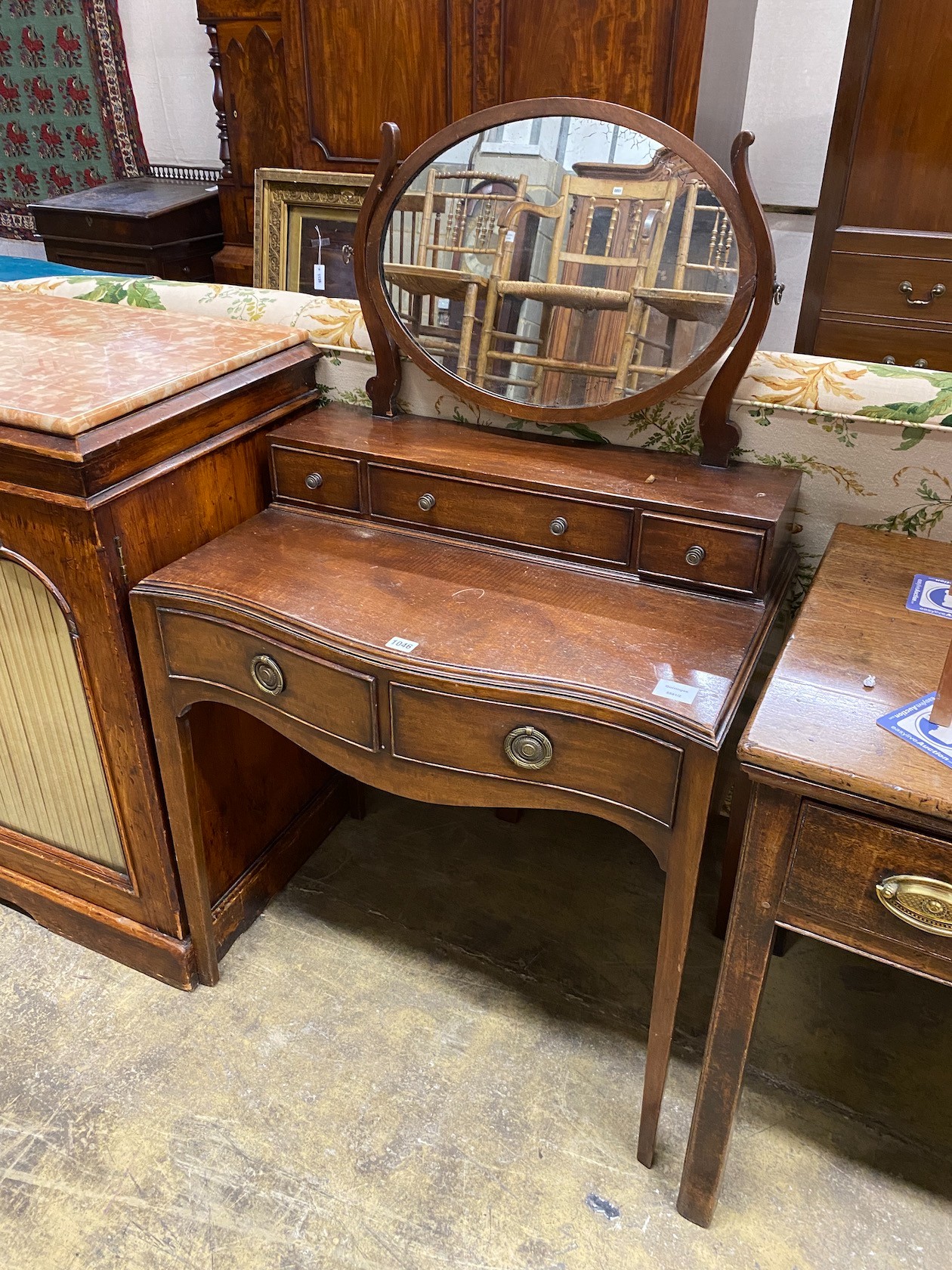 A George III style mahogany serpentine dressing table, width 72cm, depth 46cm, height 120cm